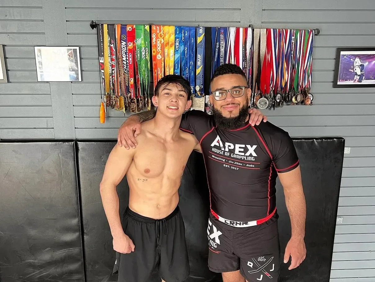Coach Nick Spacek with a young wrestler at Apex House of Grappling